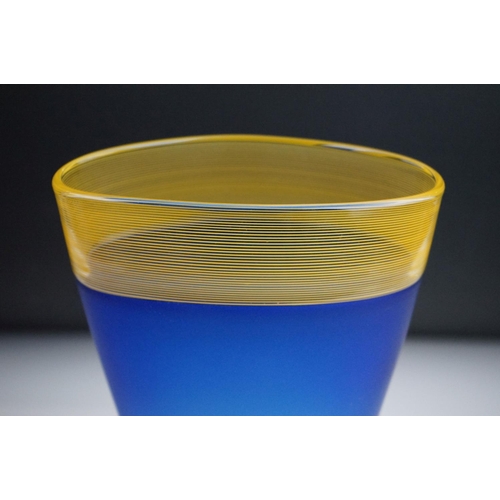 9 - Bob Crooks - A blue & pale amber threaded glass vase of flattened tapering form, with a fine threade... 