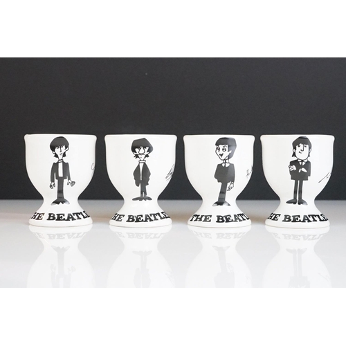 211 - Set of Four Ceramic ' The Beatles ' Egg Cups, each cup featuring a different member of the band and ... 