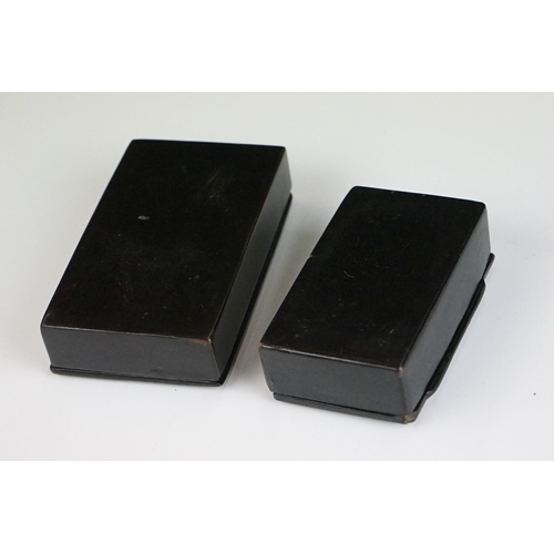 212 - Two 19th century Black Lacquered Papier Mache Snuff Boxes with pewter inlay, largest 8.5cm long