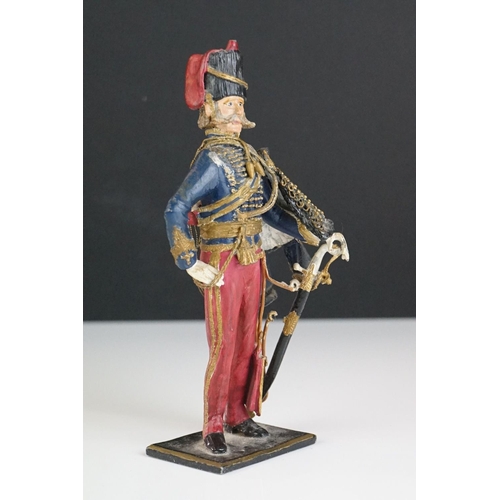 216 - A decorative painted metal soldier in traditional uniform.