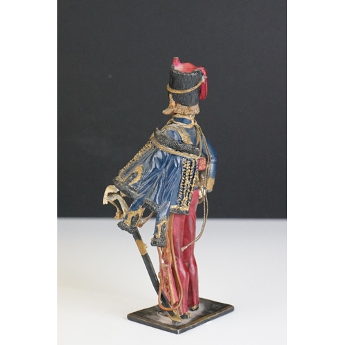 216 - A decorative painted metal soldier in traditional uniform.