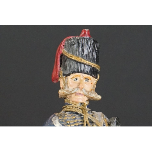 216 - A decorative painted metal soldier in traditional uniform.