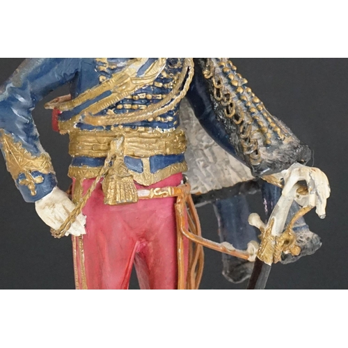 216 - A decorative painted metal soldier in traditional uniform.