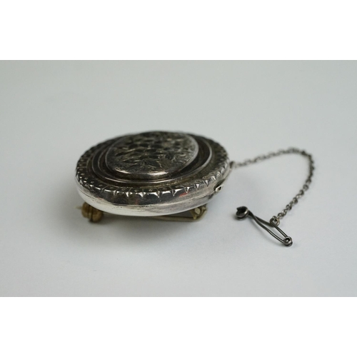 232 - A fully hallmarked sterling silver locket brooch with safety chain.