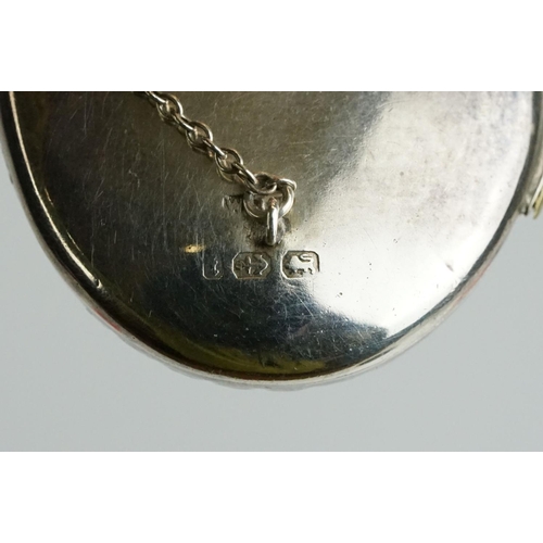 232 - A fully hallmarked sterling silver locket brooch with safety chain.