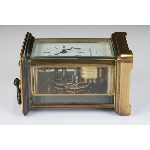 265 - A brass cased carriage clock with bevelled glass panels, Matthew Norman of London, complete with key... 