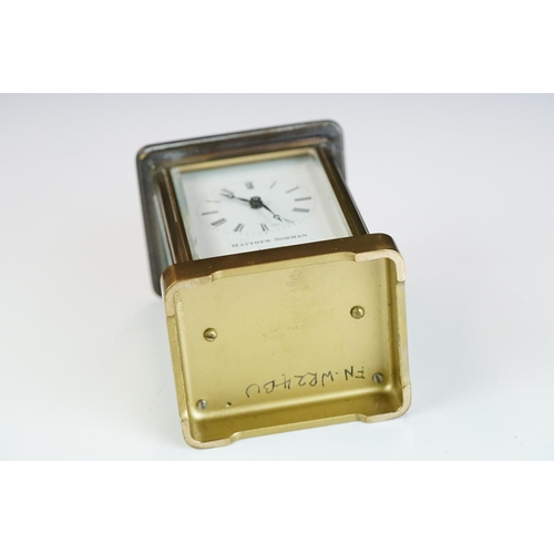 265 - A brass cased carriage clock with bevelled glass panels, Matthew Norman of London, complete with key... 