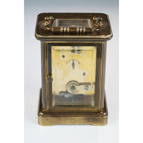 265 - A brass cased carriage clock with bevelled glass panels, Matthew Norman of London, complete with key... 