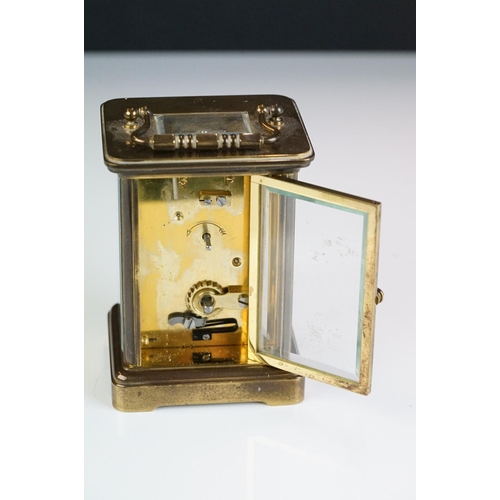 265 - A brass cased carriage clock with bevelled glass panels, Matthew Norman of London, complete with key... 