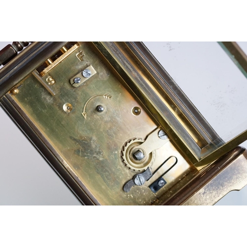 265 - A brass cased carriage clock with bevelled glass panels, Matthew Norman of London, complete with key... 