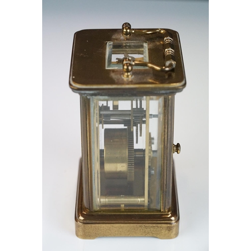 265 - A brass cased carriage clock with bevelled glass panels, Matthew Norman of London, complete with key... 