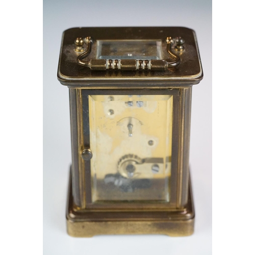 265 - A brass cased carriage clock with bevelled glass panels, Matthew Norman of London, complete with key... 