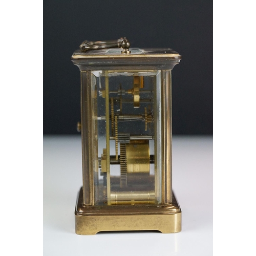 265 - A brass cased carriage clock with bevelled glass panels, Matthew Norman of London, complete with key... 