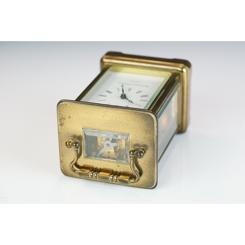 265 - A brass cased carriage clock with bevelled glass panels, Matthew Norman of London, complete with key... 