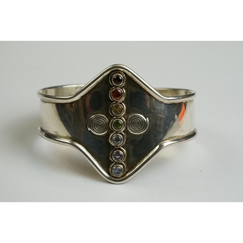 242 - Silver 925 Arts & Crafts style bangle with gem set stones, to include rock crystal, amethyst, blue t... 