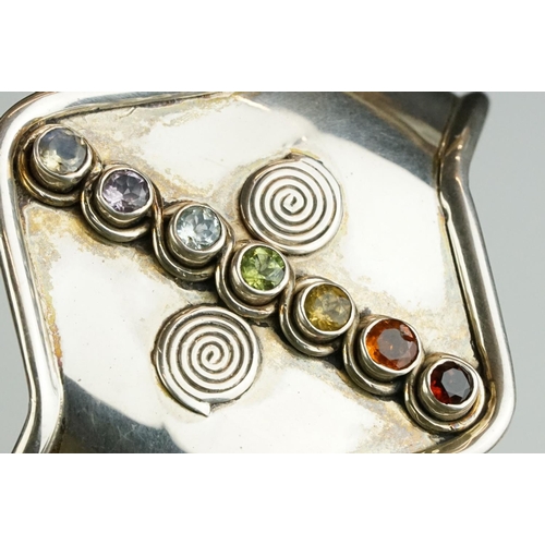 242 - Silver 925 Arts & Crafts style bangle with gem set stones, to include rock crystal, amethyst, blue t... 