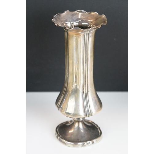 262 - A box of mixed collectables to include a hallmarked sterling silver bud vase, napkin ring, silver to... 