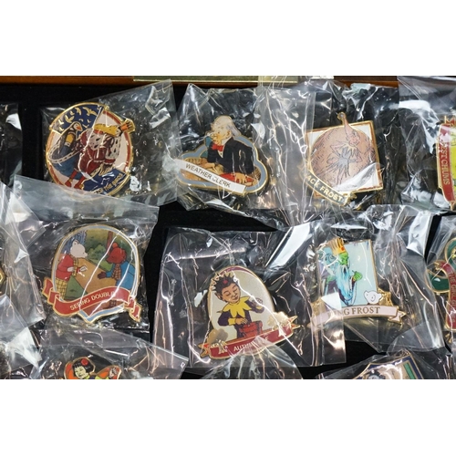 293 - A large collection of over fifty collectable Rupert The Bear pin badges contained within a glass top... 