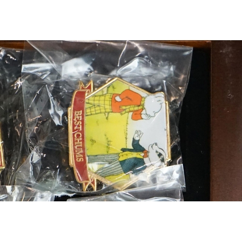 293 - A large collection of over fifty collectable Rupert The Bear pin badges contained within a glass top... 