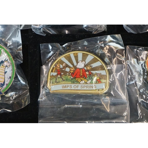 293 - A large collection of over fifty collectable Rupert The Bear pin badges contained within a glass top... 