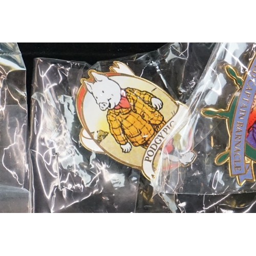 293 - A large collection of over fifty collectable Rupert The Bear pin badges contained within a glass top... 