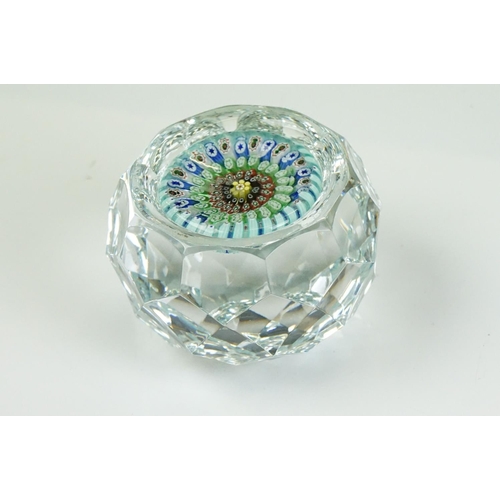 55 - Six Whitefriars faceted glass concentric millefiori paperweights, of varying colours, to include an ... 