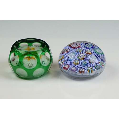 57 - Two Peter McDougal glass paperweights, to include a green overlay faceted example with central flowe... 