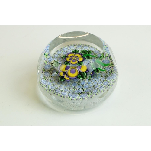 61 - Six glass paperweights to include a John Deacons faceted lamp work pansy & millefiori paperweight (w... 