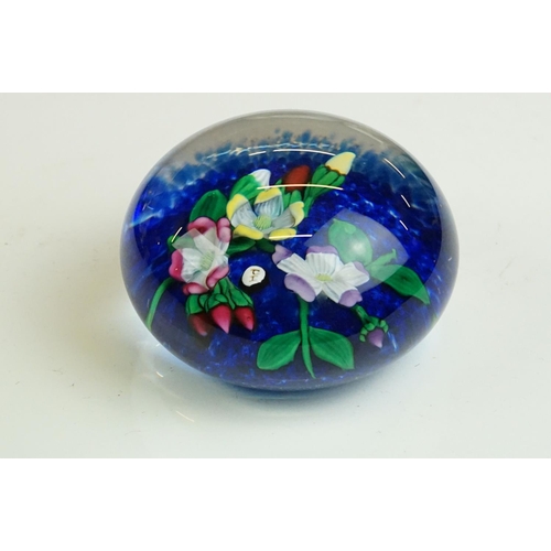 61 - Six glass paperweights to include a John Deacons faceted lamp work pansy & millefiori paperweight (w... 