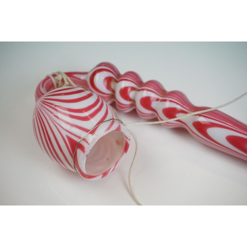 62 - Large Nailsea red and white glass 'bubble' pipe, swirl-effect design, approx 49cm long