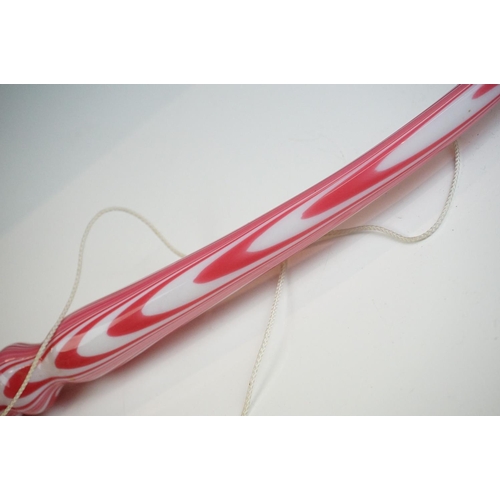 62 - Large Nailsea red and white glass 'bubble' pipe, swirl-effect design, approx 49cm long