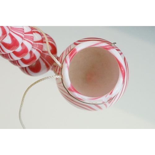 62 - Large Nailsea red and white glass 'bubble' pipe, swirl-effect design, approx 49cm long