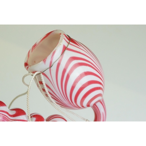 62 - Large Nailsea red and white glass 'bubble' pipe, swirl-effect design, approx 49cm long