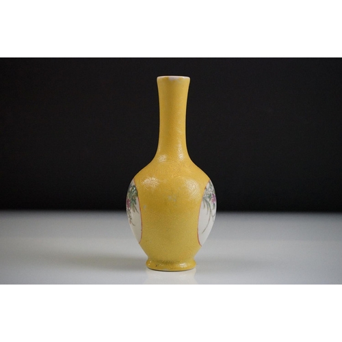 63 - Small Chinese bottle vase with Famille Rose floral panels on a yellow ground with incised scrolling ... 