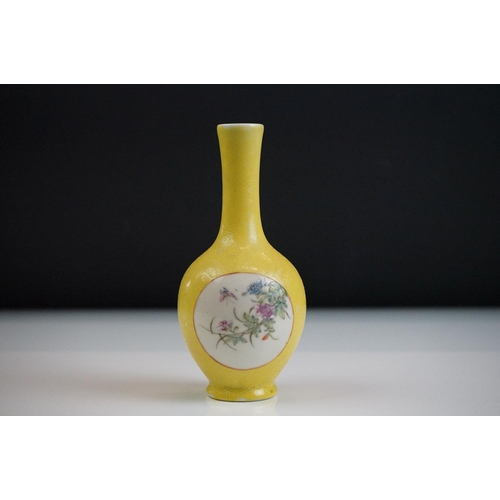 63 - Small Chinese bottle vase with Famille Rose floral panels on a yellow ground with incised scrolling ... 