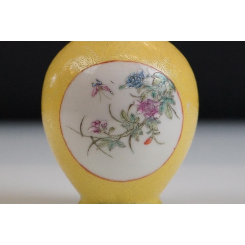 63 - Small Chinese bottle vase with Famille Rose floral panels on a yellow ground with incised scrolling ... 