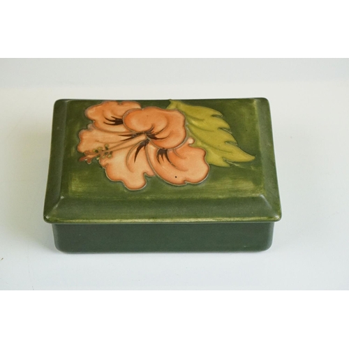 70 - Moorcroft Hibiscus pattern lidded trinket box on green ground, underglaze 'Moorcroft' mark to base, ... 