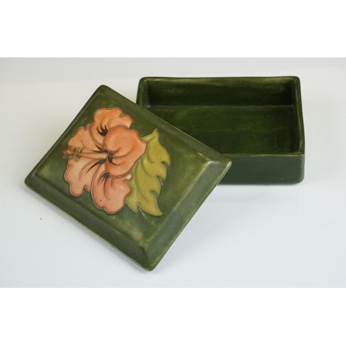 70 - Moorcroft Hibiscus pattern lidded trinket box on green ground, underglaze 'Moorcroft' mark to base, ... 