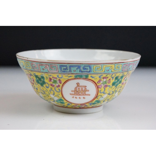 72 - Chinese yellow ground circular bowl with scrolling Famille Rose floral decoration, four character ma... 