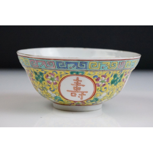 72 - Chinese yellow ground circular bowl with scrolling Famille Rose floral decoration, four character ma... 