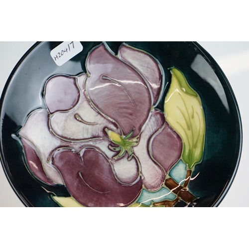 73 - Two Moorcroft pin dishes, floral patterns, 11.5cm diameter