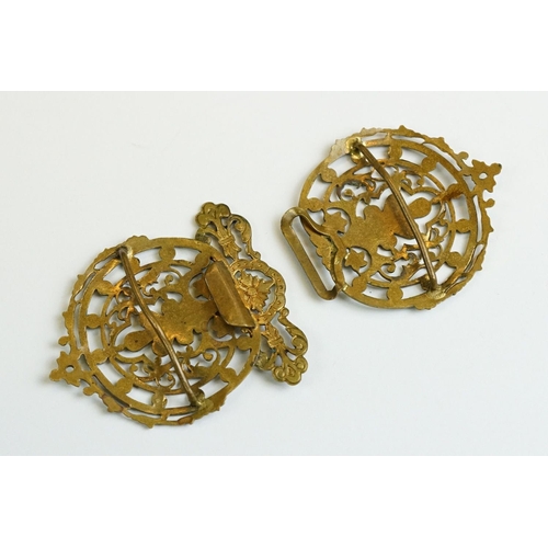 222 - An ornate brass two piece belt buckle with enamel decoration.