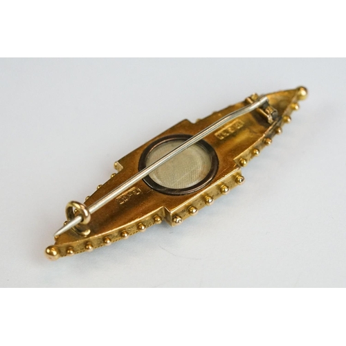 228 - An antique 15ct gold Victorian mourning brooch with filigree and seed pearl decoration and hair pane... 