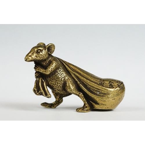 229 - A small brass ornamental Rat carrying bag of wealth figure.