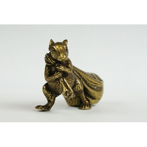 229 - A small brass ornamental Rat carrying bag of wealth figure.