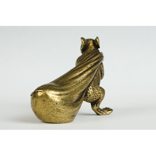 229 - A small brass ornamental Rat carrying bag of wealth figure.