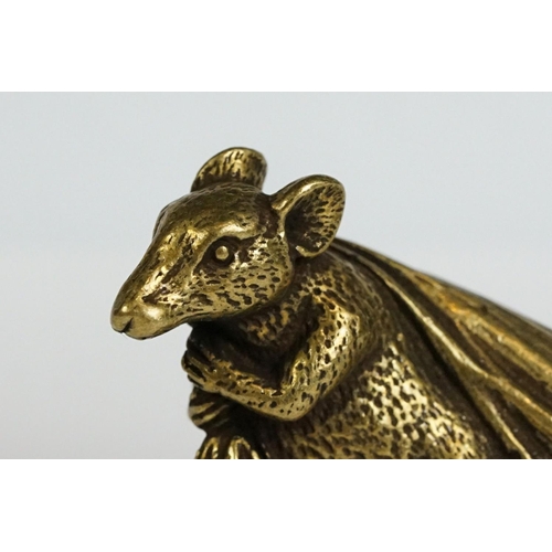 229 - A small brass ornamental Rat carrying bag of wealth figure.