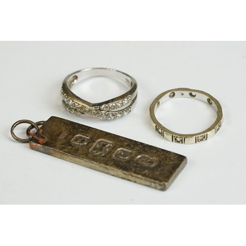 230 - A fully hallmarked sterling silver ingot pendant together with two rings.