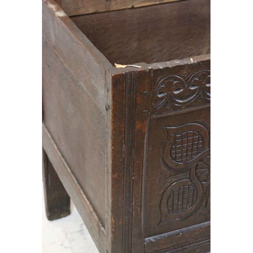 557 - 18th century Oak Coffer with two plank top and three carved panels to front, raised on stile legs, 1... 