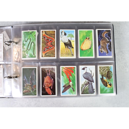 411 - A large collection of cigarette cards contained within twelve albums, full sets and part sets, date ... 